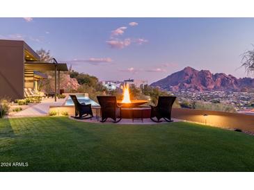 Backyard with firepit and seating area, offering stunning mountain views at 4060 E Lamar Rd, Paradise Valley, AZ 85253