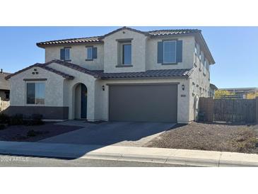 Two-story house with gray garage door and landscaped front yard at 18231 W Vista Norte St, Goodyear, AZ 85338