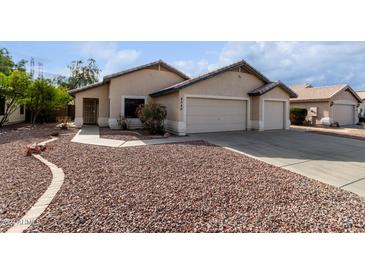 House exterior boasts a two-car garage and well-maintained landscaping at 8549 W El Caminito Dr, Peoria, AZ 85345