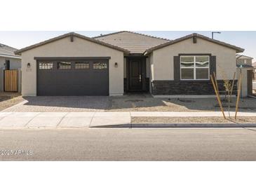 One-story home with a two-car garage, stone accents and landscaping at 17709 W Southgate Ave, Goodyear, AZ 85338