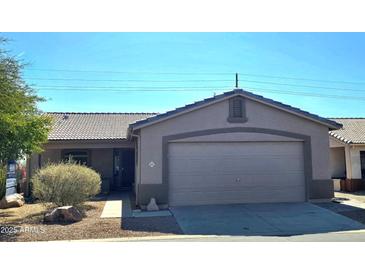 Charming single-story home with a well-maintained front yard and a two-car garage at 2101 S Meridian Rd # 421, Apache Junction, AZ 85120