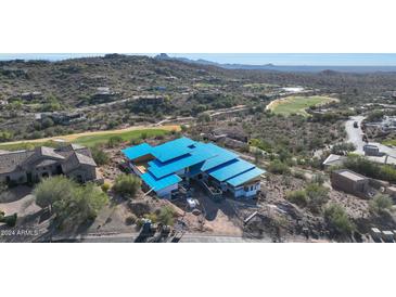 Aerial view of a modern home under construction, nestled in a luxury golf course community at 9609 N Palisades Blvd, Fountain Hills, AZ 85268