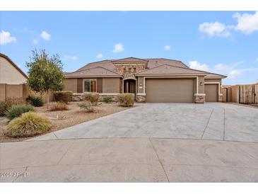 Beautiful two-story home with a three-car garage and desert landscaping at 5531 W Gwen St, Laveen, AZ 85339