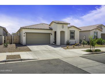 Charming single-story home featuring desert landscaping, a two-car garage, and a welcoming front porch at 40015 W Crane Dr, Maricopa, AZ 85138