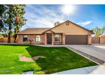 Brick ranch home with a 2-car garage and well-manicured lawn at 4343 E Downing St, Mesa, AZ 85205