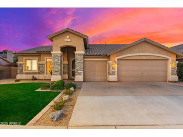 Two-story home with a three-car garage and manicured lawn at 2257 W Periwinkle Way, Chandler, AZ 85248