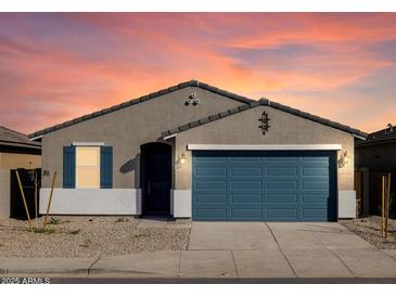 Charming single-story home showcasing a well-maintained front yard and a blue two-car garage at 37028 W Prado St, Maricopa, AZ 85138