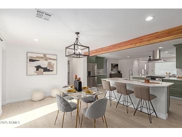 Modern kitchen with white quartz countertops and sage green cabinets at 1829 E Amelia Ave, Phoenix, AZ 85016