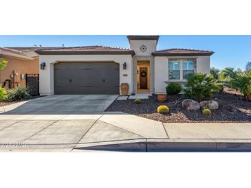 Single-story home with desert landscaping and a two-car garage at 97 E Alcatara Ave, San Tan Valley, AZ 85140