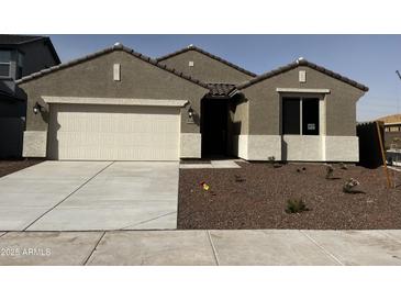 Charming single-story home with a two car garage, desert landscaping and a well-maintained front yard at 17540 W Lupine Ave, Goodyear, AZ 85338