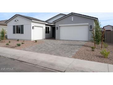 Charming home with a two-car garage, a one-car garage, and a paved driveway, offering ample parking space at 3909 E Gold Mountain Ave, San Tan Valley, AZ 85143