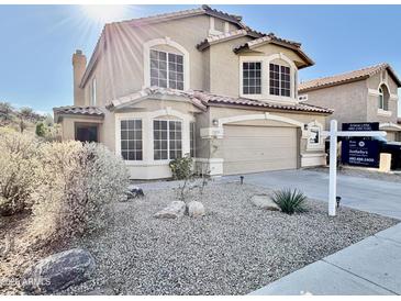 Charming two-story home with a two-car garage and desert landscaping at 20436 N 17Th Pl, Phoenix, AZ 85024