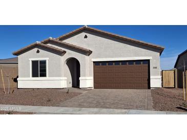 Charming single-story home featuring a two-car garage, neutral stucco, and a paved driveway at 27969 N 176Th Ave, Surprise, AZ 85387