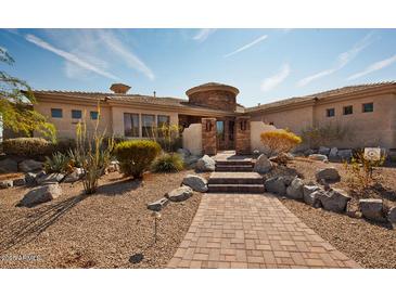 Desert landscape surrounds this single-story home with a circular drive at 11461 S Wilson Ln, Goodyear, AZ 85338