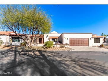 Spanish style home with landscaped front yard and two-car garage at 26223 N Bravo Ln, Rio Verde, AZ 85263