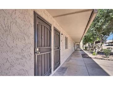 Exterior view of condo building showcasing building facade and walkway at 7625 E Camelback Rd # B116, Scottsdale, AZ 85251