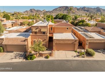 Aerial view of a two-story home with a tile roof and a mountain backdrop at 10653 N 10Th Pl, Phoenix, AZ 85020