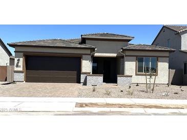 Charming single-story home with a well-maintained front yard and a two-car garage at 43513 N Wollemi St, Queen Creek, AZ 85140
