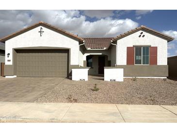 Charming single-story home featuring a neutral-colored stucco finish, tile roofing, and an attached two-car garage at 43429 N Wollemi St, Queen Creek, AZ 85140