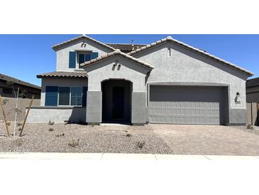 Beautiful two-story home with a two-car garage and stylish blue shutters at 43499 N Wollemi St, Queen Creek, AZ 85140