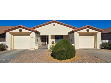 Charming single-story home with dual garages, desert landscaping, and a secure, gated front entryway at 2101 S Meridian Rd # 274, Apache Junction, AZ 85120