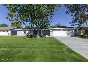 Ranch style home with spacious lawn and attached garage at 4034 E Osborn Rd, Phoenix, AZ 85018