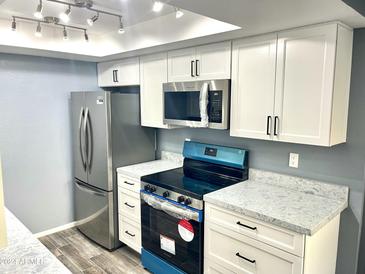 Modern kitchen features stainless steel appliances and updated countertops at 1230 N 84Th Pl, Scottsdale, AZ 85257