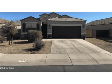 Charming single-story home featuring a well-maintained landscape, a two-car garage, and neutral color palette at 268 S San Jose Ln, Casa Grande, AZ 85194