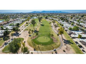 Stunning aerial view of the golf course, surrounded by homes in the community at 10214 E Michigan Ave, Sun Lakes, AZ 85248