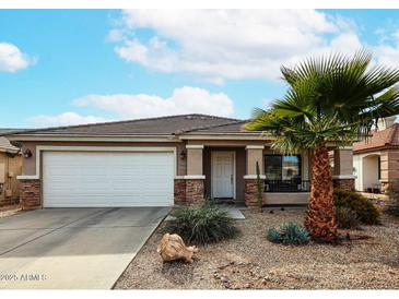 One-story house with a two-car garage and desert landscaping at 17475 W Caribbean Ln, Surprise, AZ 85388