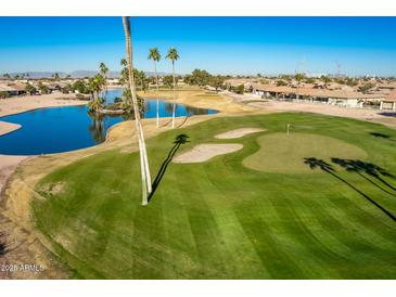 Aerial view of the golf course community with a lake and houses at 9048 E Cedar Waxwing Dr, Sun Lakes, AZ 85248