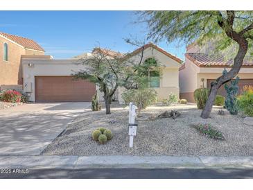 Single-story home with desert landscaping and two-car garage at 23635 N 75Th Pl, Scottsdale, AZ 85255