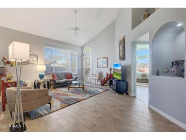 Bright living room featuring vaulted ceilings and tile floors at 23635 N 75Th Pl, Scottsdale, AZ 85255