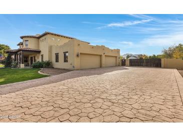 Spacious three-car garage with a stamped concrete driveway at 2697 E Via Del Arboles --, Gilbert, AZ 85298
