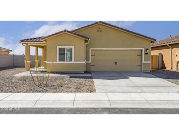 Home exterior showing the garage and a low-maintenance gravel front yard with sidewalk at 659 W Pintail Dr, Casa Grande, AZ 85122