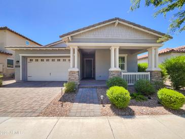 Charming single-story home with a well-manicured front yard and inviting covered porch at 10559 E Simone Ave, Mesa, AZ 85212