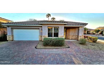 One-story home with brick facade and landscaped front yard at 13613 W Cypress St, Goodyear, AZ 85395