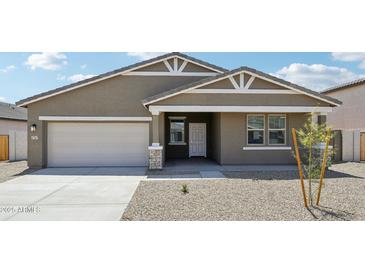 Charming single-story home with a two-car garage and a meticulously graveled front yard at 47267 W Mellen Ln, Maricopa, AZ 85139