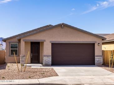 Charming single-story home with desert landscaping, stone accents, and a two-car garage at 9120 N 174Th Ln, Waddell, AZ 85355