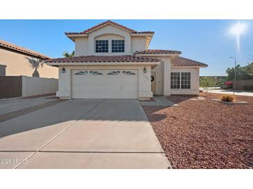 Two-story house with a two-car garage and landscaped front yard at 1705 E Windsong Dr, Phoenix, AZ 85048