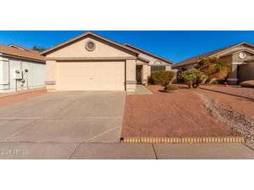 Tan house with a beige garage door and small front yard at 3150 W Foothill Dr, Phoenix, AZ 85027