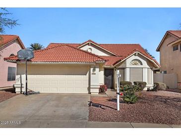 Charming home with a terracotta tile roof, well-kept landscaping, and a two-car garage at 3530 E Long Lake Rd, Phoenix, AZ 85048