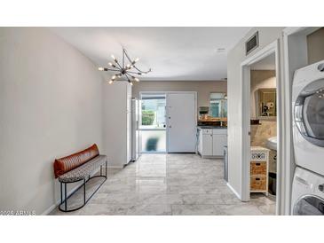 Bright kitchen features stainless appliances, tile floors, and a unique chandelier lighting fixture at 4600 N 68Th St # 313, Scottsdale, AZ 85251