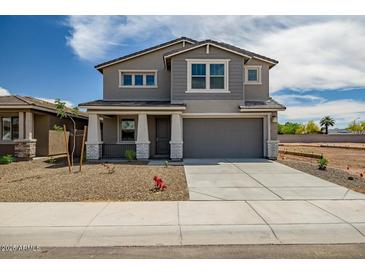 Charming two-story home with a large driveway and well-maintained gravel landscaping at 5534 W Banff Ln, Glendale, AZ 85306