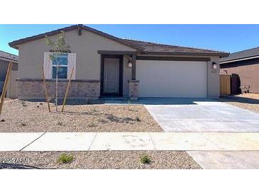 Charming single-story home featuring a two-car garage and low-maintenance front yard at 22489 W Pontiac Dr, Surprise, AZ 85387