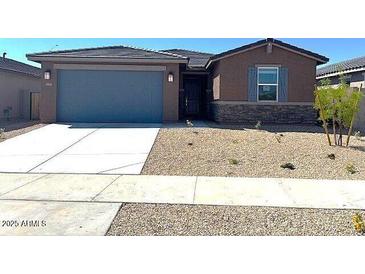 Charming single-story home featuring low maintenance desert landscaping and a convenient two-car garage at 22507 W Pontiac Dr, Surprise, AZ 85387