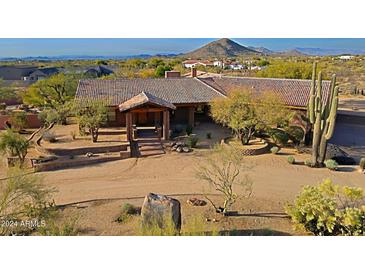 Stunning aerial view of a luxurious home with a large yard and mountain backdrop at 8505 E Morning Vista Rd, Scottsdale, AZ 85266