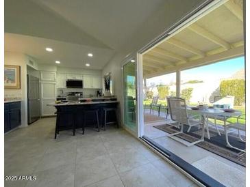 Contemporary kitchen featuring a large island and a seamless transition to the outdoor patio area at 4302 E Evans Dr, Phoenix, AZ 85032