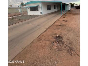 Mobile home exterior with carport and small yard at 714 S 86Th Pl, Mesa, AZ 85208