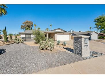 Single-story home with a landscaped front yard and a two-car garage at 5240 E Tierra Buena Ln, Scottsdale, AZ 85254